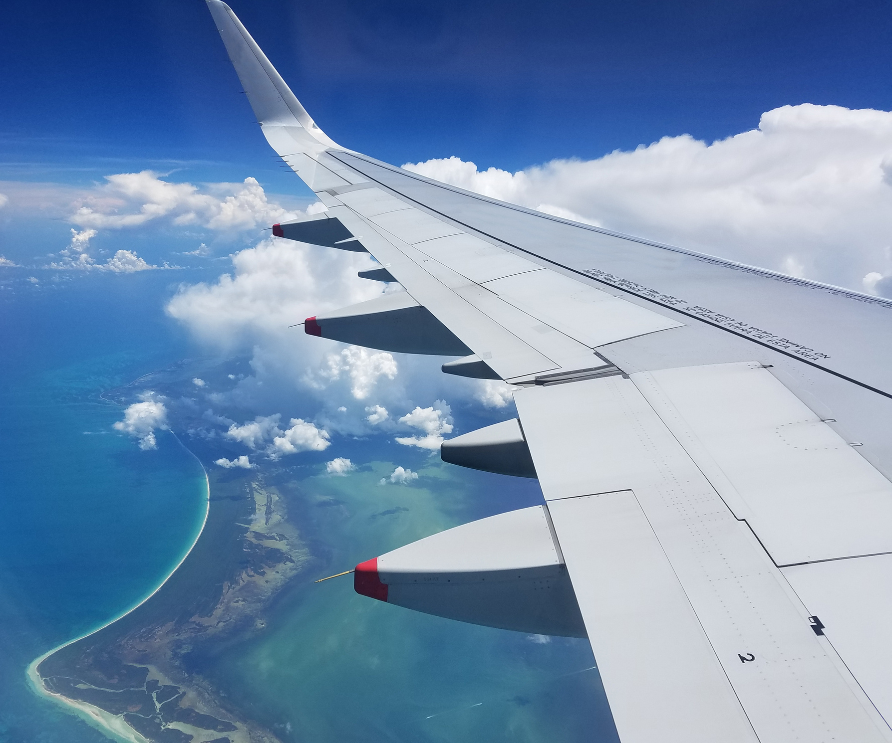 Airplane Wing View above the Caribbean Sea.